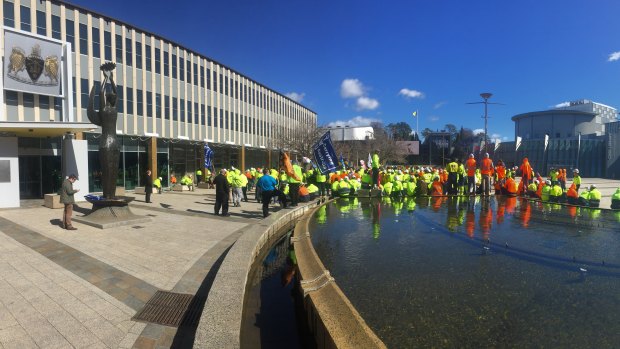 Members of ACT unions rally outside the ACT Legislative Assembly.