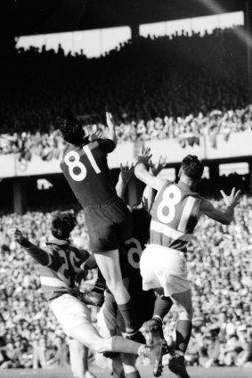 Players leap for the ball. 