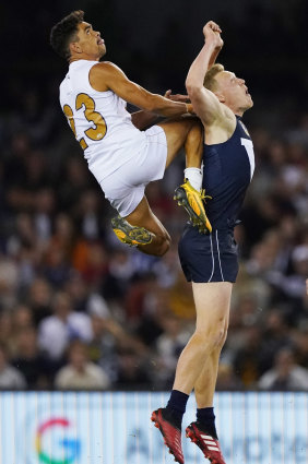 Charlie Cameron of the All-Stars flies high  for a mark over James Sicily.