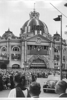 The Royal couple arrives at St Paul's Cathedral, in the background Flinders Street Station is decorated for the visit.