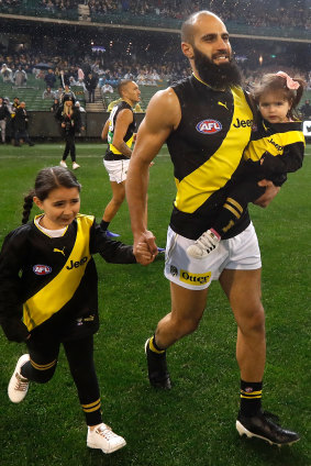 On the field with daughters Sarah and Maryam last year at his 200th game.