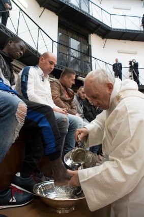 Pope Francis washes the feet of inmates during his visit to a detention centre in Rome in a pre-Easter ritual.