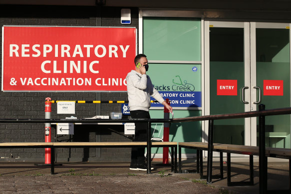 A man talks on his phone outside a vaccination clinic at Slacks Creek as millions of Queenslanders continue to be locked down.