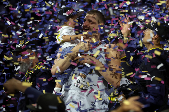 Nikola Jokic celebrates with his daughter Ognjena. 