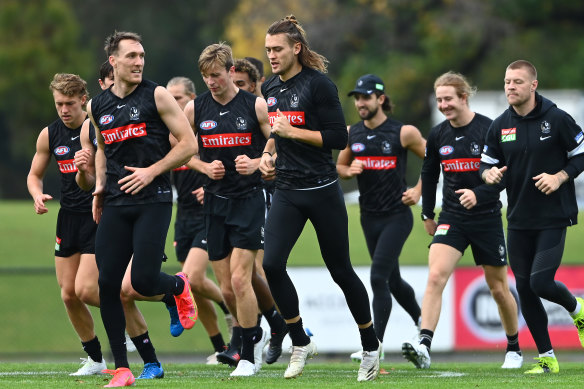 On the run: Collingwood players training this week.