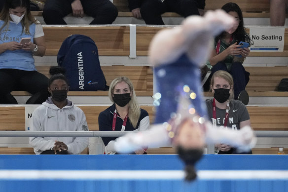 Simone Biles watches Lee from the stands.