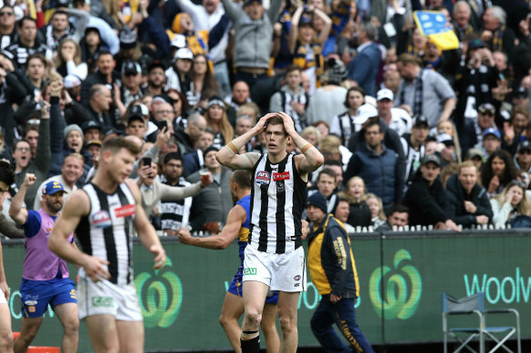 Sinking feeling: Magpies Taylor Adams and Mason Cox react after Luke Sheed kicks the winning goal for West Coast in the grand final in 2018.