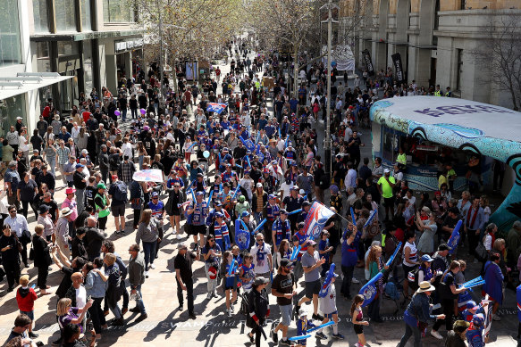 Fans march down Murray Street in Perth’s CBD during the People’s Parade ahead of the 2021 AFL grand final, at Optus Stadium. 
