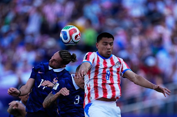 France’s Adrien Rabiot and Lucas Digne go for a header with Paraguay’s Diego Gomez.