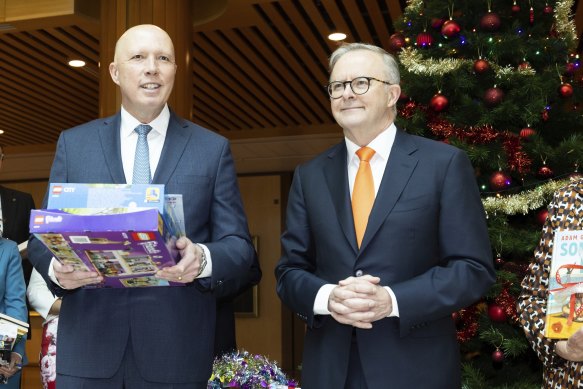Peter Dutton and Anthony Albanese, in a rare moment of unity, giving Christmas presents at the Parliament House wishing tree.