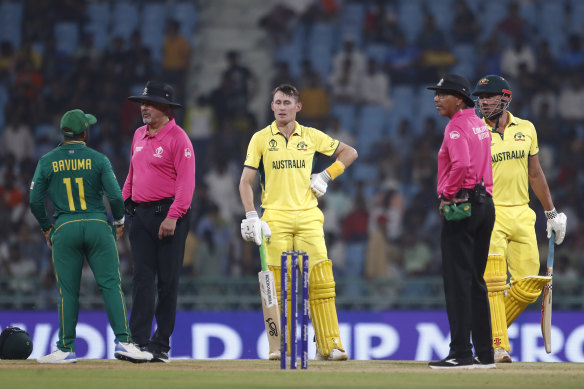 Marnus Labuschagne and Marcus Stoinis speak with South Africa’s Temba Bavuma and match umpires Richard Illingworth and Joel Wilson after being dismissed from a review.