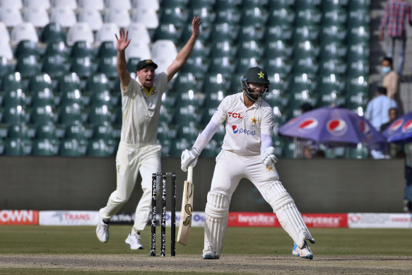 Pakistan’s Imam-ul-Haq, right, reacts while Australia’s Cameron Green celebrates his dismissal.