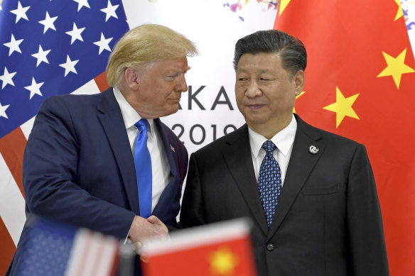 Donald Trump, pictured here with Xi Jinping in 2019, is obsessed by China, Bolton says.