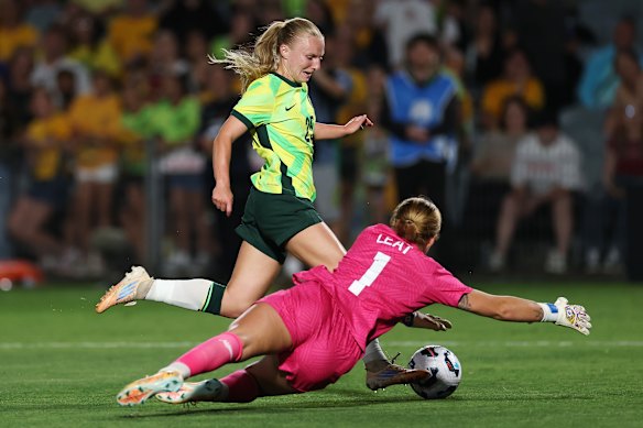Holly McNamara of the Matildas is fouled by New Zealand goal keeper Anna Leat.