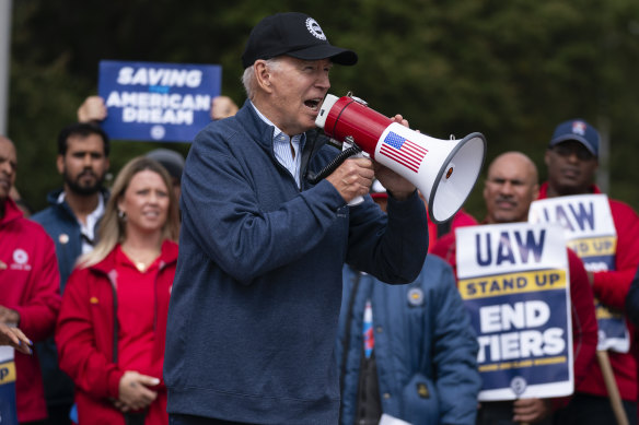 President Joe Biden speaks to striking United Auto Workers on the picket line in Michigan last year. 