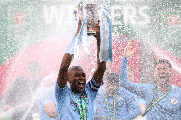 Fernandinho holds the Carabao Cup aloft for Manchester City after beating Tottenham Hotspur at Wembley.