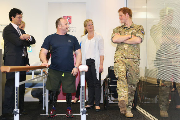 Prince Harry with amputee Lieutenant Ali Spearing, who lost both legs in Afghanistan, and Munjed Al Muderis.