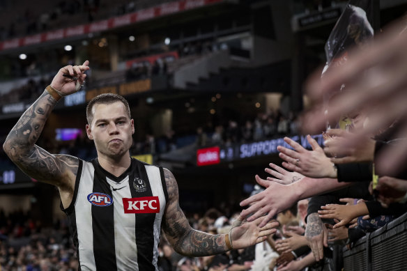 Jamie Elliott celebrates with Magpies fans.