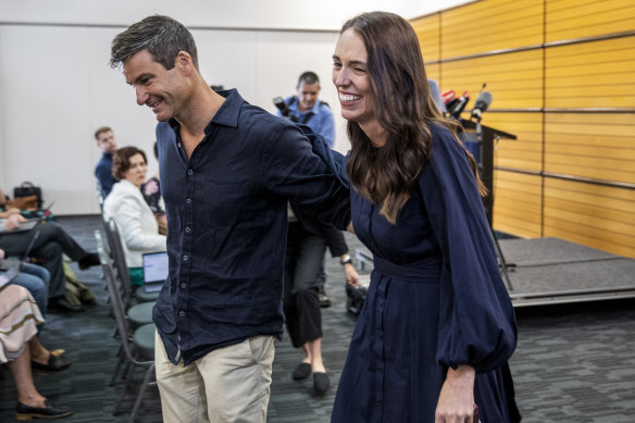 New Zealand Prime Minister Jacinda Ardern walks away with her fiance Clark Gayford after announcing her resignation.