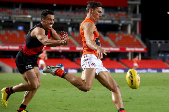 Isaac Cumming gets a kick away for the Giants.