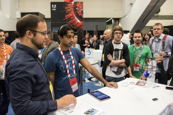 Siddharth Hariharoan focuses on controlling a toy helicopter with his mind through the MindWaveMobile, a device by NeuroSky that reads brainwaves, during GDC 2013, a game developer conference in San Francisco.