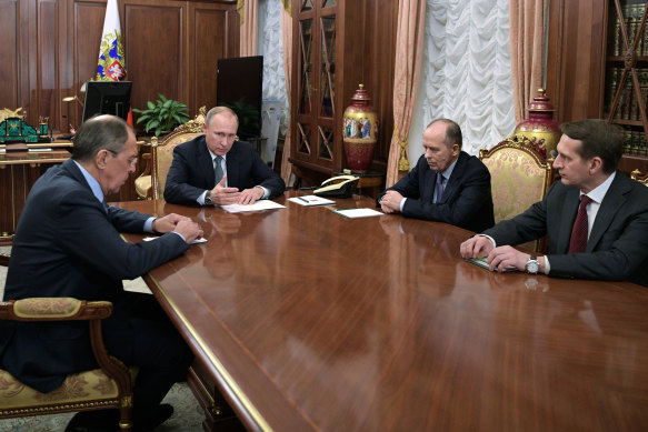 Russian President Vladimir Putin talks with Foreign Minister Sergey Lavrov, left, Federal Security Service head Alexander Bortnikov, second right, and Foreign Intelligence Service Sergei Naryshkin in 2016.