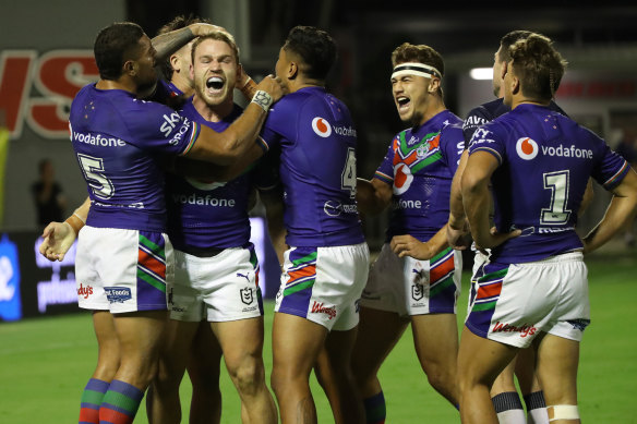 Euan Aitkin of the Warriors celebrates after scoring a try against the Cowboys.