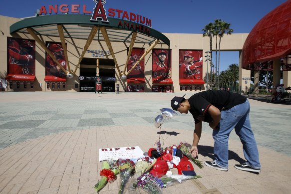 A fan adds to a makeshift memorial for Skaggs at Angel Stadium.
