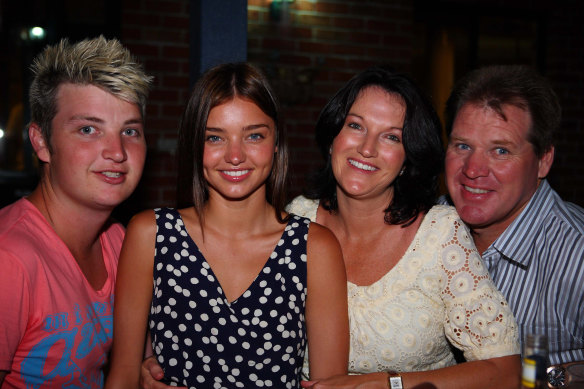 Miranda Kerr smiles while taking time out with family and friends on the mid-north coast near Coffs Harbour. From left: brother Matty, Miranda, mother Theresa and John.