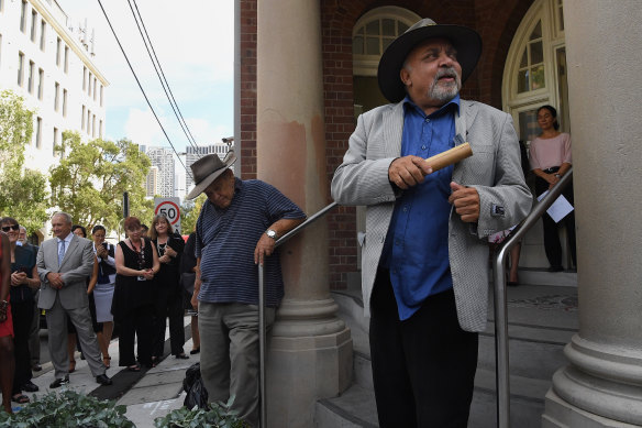 Aboriginal elders Uncle Greg Simms, centre, and Uncle Wes Marne, left, conduct a smoking ceremony to mark the opening of the Youth Koori Court at Surry Hills in 2019. The court is being expanded to Dubbo.