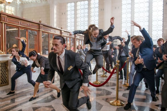 Julian Rosefeldt’s Euphoria features bank workers breaking into wild dance.