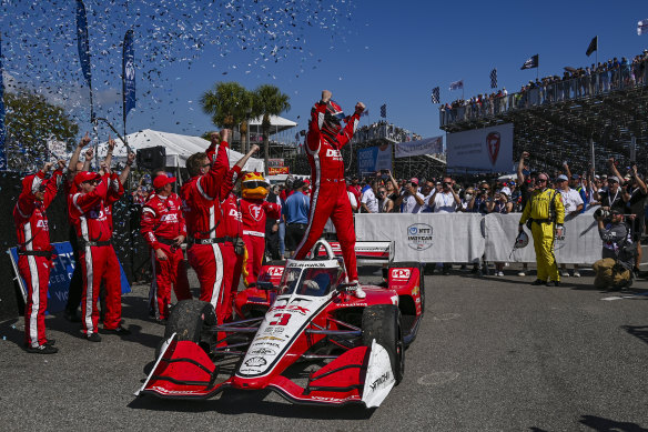 Scott McLaughlin stands on his car as he celebrates victory.