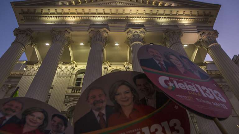 Demonstrators hold Workers' Party (PT) signs during a rally against local government officials and in support of the jailed former president  in Curitiba, Brazil.
