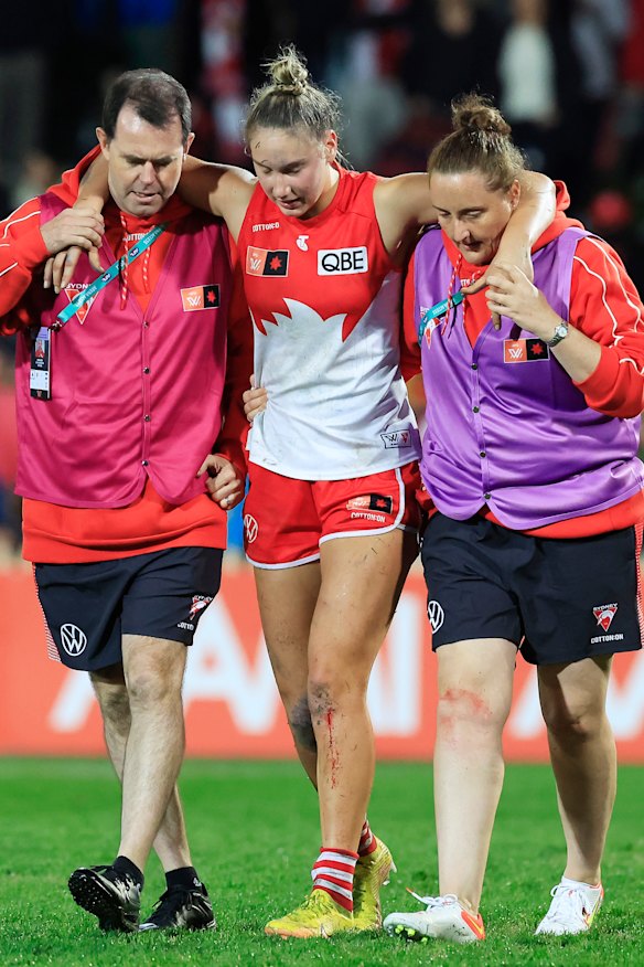 Montana Ham is helped from the field.