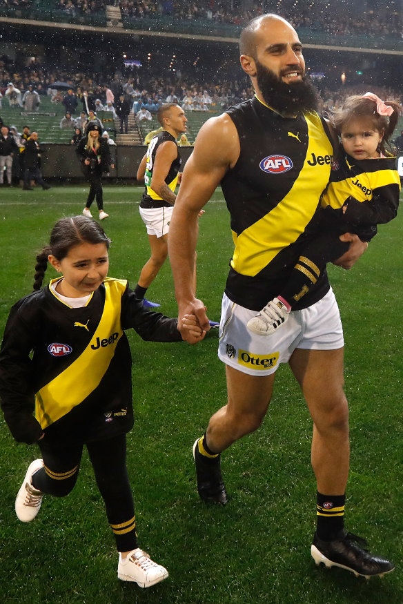 On the field with daughters Sarah and Maryam last year at his 200th game.