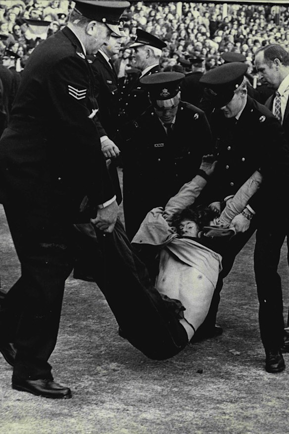 Demonstrator being removed by police