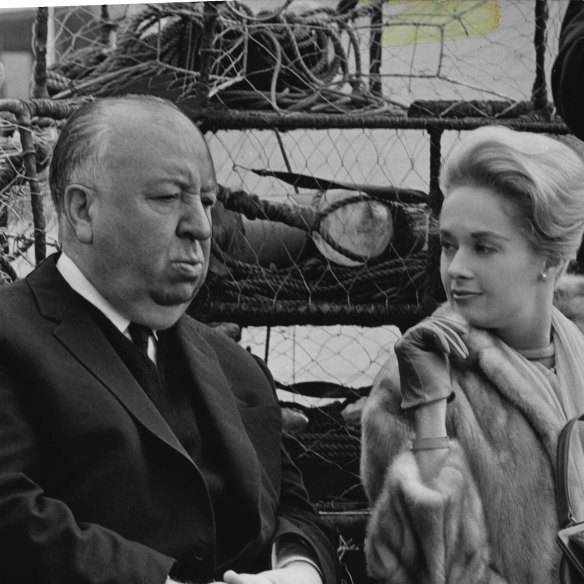 Alfred Hitchcock talks with his leading lady, Tippi Hedren, at the 1963 Cannes Film Festival premiere of The Birds.