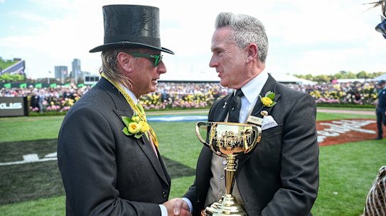 Outgoing VRC chair Neil Wilson (right) with the Melbourne Cup.