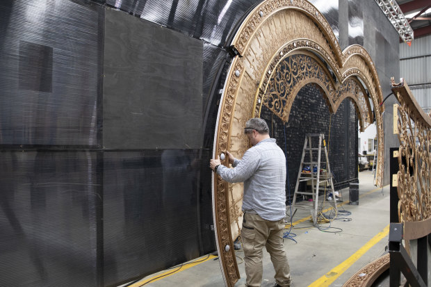 Crew install the heart-shaped portal that forms the centrepiece of Moulin Rouge! The Musical!