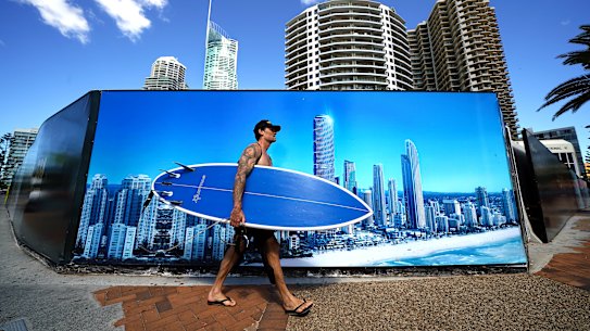 A lone surfer on the Gold Coast heads to the beach on Thursday. 