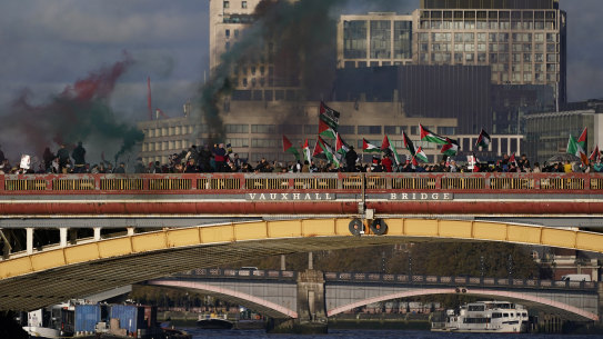 Protesters wave flags and hold flares during a pro-Palestinian protest in London on Saturday.