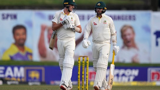 Pat Cummins and Nathan Lyon leave the ground when play is abandoned early because of bad light.