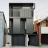 The house (right) has a two-level black steel facade that adds a sense of mystery.