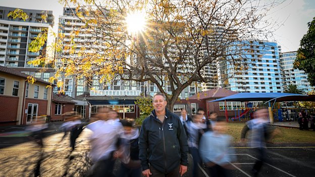  St Monica’s Primary School principal Nathan Owen and students underneath their ‘friendship tree’.