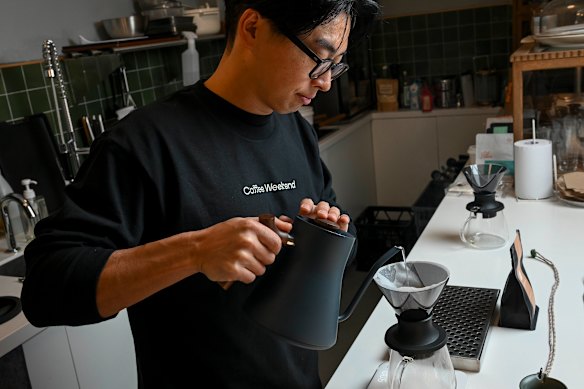 Okada at work in his coffee lab and office.