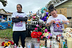 Julius Windham visits a memorial outside the home where authorities say a gunman killed multiple people, including his daughter.