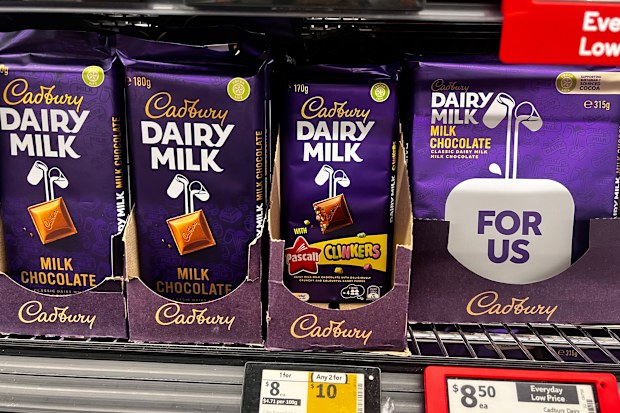 Blocks of Cadbury chocolate on a supermarket shelf.