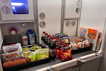 There was so much food loaded onto the flight some had to be stored in the overhead bins.
