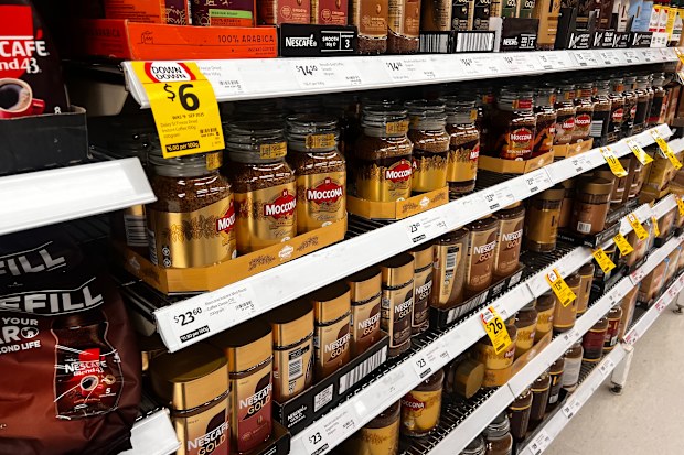 Jars of instant coffee sitting on supermarket shelves.