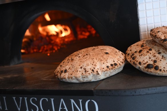 The wood-fired stove pumps out the signature puffy bread.